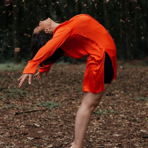 Person stretching near a window at sunrise, feeling refreshed and full of life.
