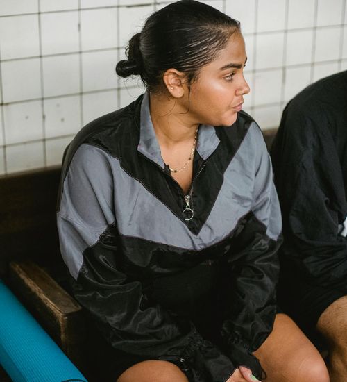 Smiling woman in sportswear feeling energetic and positive after a workout.